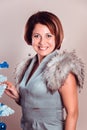 Portrait of elegant lady in  fur collar stands near the New Year tree Royalty Free Stock Photo