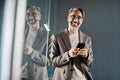 Portrait of elegant mature business man wearing suit using mobile cell phone. Royalty Free Stock Photo