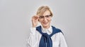 Portrait of elegant middle aged caucasian woman wearing business attire adjusting her glasses, smiling at camera while Royalty Free Stock Photo