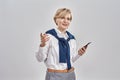 Portrait of elegant middle aged caucasian woman wearing business attire and earphones holding smartphone, smiling away