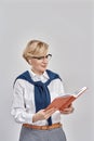 Portrait of elegant middle aged caucasian woman wearing business attire and glasses holding, looking at her notebook Royalty Free Stock Photo