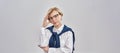 Portrait of elegant middle aged caucasian woman wearing business attire and glasses looking thoughtful at camera while Royalty Free Stock Photo