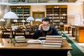 Portrait of elegant senior man, university school teacher, wruter, with beard and eyeglasses, reading books in vintage Royalty Free Stock Photo