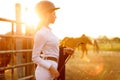 Rider woman with whip at the sunset Royalty Free Stock Photo