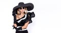 Portrait of elegant woman in a big hat and sunglasses isolated on a white background in studio. Retro style. Pretty lady in hat. Royalty Free Stock Photo