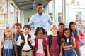 Portrait of elementary school kids and teacher in corridor Royalty Free Stock Photo