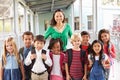 Portrait of elementary school kids and teacher in corridor Royalty Free Stock Photo