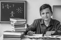 Portrait of elementary school student doing homework. Black and white photo. Royalty Free Stock Photo