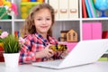 Portrait of emotional cute girl using laptop Royalty Free Stock Photo