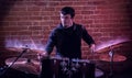 Portrait of emotional drummer rehearsing on drums. Royalty Free Stock Photo