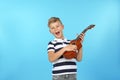 Portrait of emotional little boy playing guitar Royalty Free Stock Photo