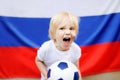 Portrait of emotional little boy with russian flag on background