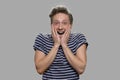 Portrait of emotional teen boy on gray background. Royalty Free Stock Photo