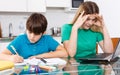 Displeased family doing homework Royalty Free Stock Photo