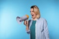 Portrait of emotional woman using megaphone