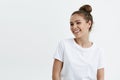 Portrait of emotive good-looking caucasian woman laughing while looking aside and standing against white background