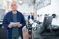 Portrait of an employee of printing house with stack of paper in his hands