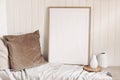 Portrait empty wooden frame mockup with linen cloth, velvet cushions and modern ceramic vases. White beadboard wainscot Royalty Free Stock Photo