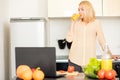 Woman using laptop in the kitchen Royalty Free Stock Photo