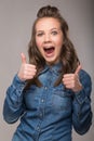 Portrait of energetic fun girl student on a gray background in a