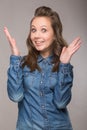 Portrait of energetic fun girl student on a gray background in a