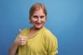 portrait of energetic healthy middle aged blond woman with t-shirt