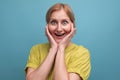 portrait of energetic healthy middle aged blond woman with t-shirt