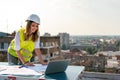 Portrait of engineer businesswoman at construction site. Female architect with blueprint. Royalty Free Stock Photo