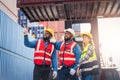 Portrait of Engineer or foreman team pointing up the future with cargo container background at sunset. Logistics global import or Royalty Free Stock Photo