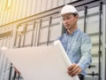 Portrait of an engineer man with helmet looking paper plans at construction site, Project engineer Royalty Free Stock Photo