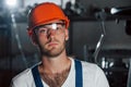 Portrait of engineer in metallurgical factory in protective helmet and eyewear