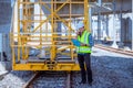 Portrait engineer under inspection and checking construction process railway and checking work on railroad station .Engineer weari