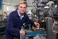 Portrait Of Engineer Using Drill In Factory