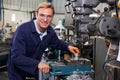 Portrait Of Engineer Using Drill In Factory