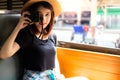 Portrait enjoying life of beautiful traveler woman. Charming beautiful girl is taking photo at vintage or old train station. Royalty Free Stock Photo