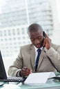 Portrait of an entrepreneur making a phone call while reading a Royalty Free Stock Photo