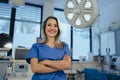 Portrait of ER doctor in hospital working in emergency room. Portrait of beautiful nurse in blue uniform, crossed arms Royalty Free Stock Photo