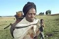 Portrait of Ethiopian woman lugging drinking water Royalty Free Stock Photo