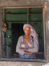 Portrait of Ethiopian woman in traditional dress behind a window Harar Ethiopia, Africa