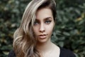 Portrait of a European attractive young woman with a sweet smile with beautiful blue eyes with blond hair in a black t-shirt Royalty Free Stock Photo