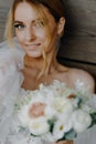 portrait of european bride with wedding bouquet in hand, vertical photo