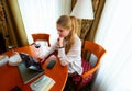 Portrait of european business woman paying bills online with laptop in office. Beautiful girl with computer and Royalty Free Stock Photo