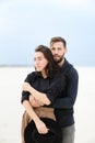 Portrait of european man hugging woman in monophonic background. Royalty Free Stock Photo