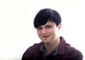 Portrait of a European young man, 21 years old, against a white background