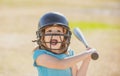 Portrait of excited amazed kid baseball player wearing helmet and hold baseball bat. Funny kids sports face. Royalty Free Stock Photo