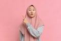 Portrait of Excited Asian beautiful young muslim woman pointing a copy space Royalty Free Stock Photo