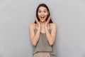 Portrait of an excited asian woman looking at camera