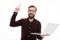 Portrait of an excited bearded man holding laptop computer Royalty Free Stock Photo