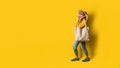 Portrait of an excited beautiful girl wearing dress and sunglasses holding shopping bags. Cheerful young woman with handbag on Royalty Free Stock Photo