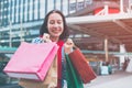 Portrait of an excited beautiful young girl wear shirt holding many shopping bags and smile. With copy space. Royalty Free Stock Photo